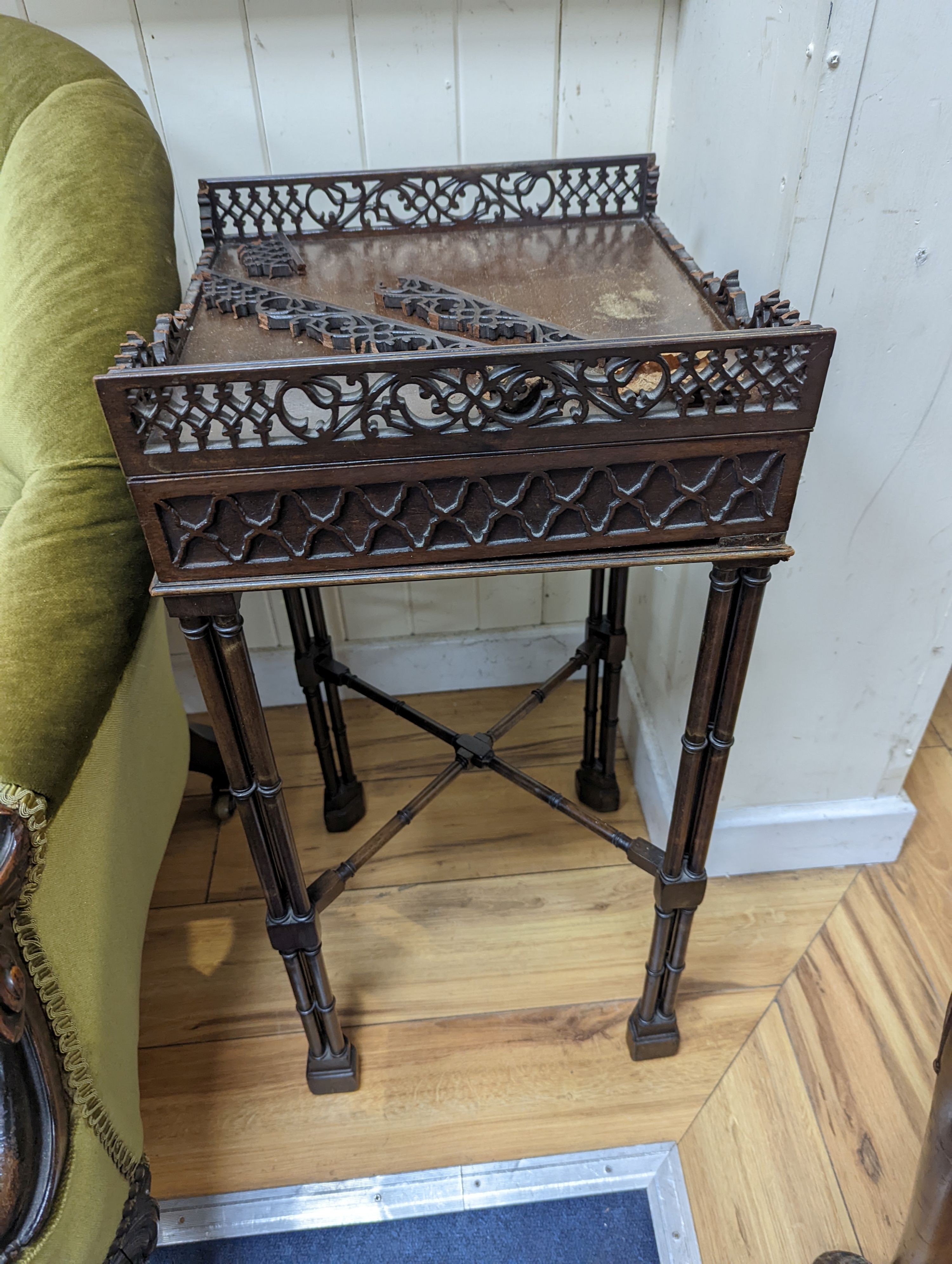 A pair of George III style square mahogany fret cut urn stands on cluster column legs, (one in need of repair) width 34cm, height 72cm